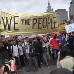 Saturday, October 1rst, 2011 - OWS protesters marching on the Brooklyn Bridge. More than 700 people were arrested, including freelance photographers, videographers and journalists. In this picture, demonstrators are carrying a sign with the phrase, "We the people".