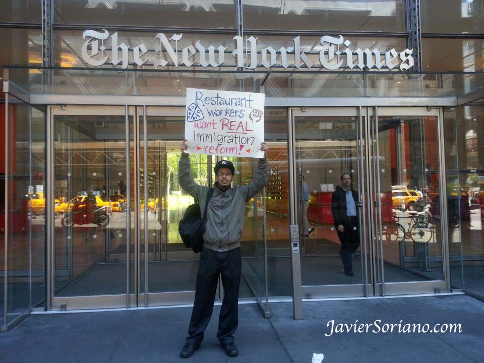 Wednesday, May 1, 2013. New York City - International Workers' Day.    Miércoles 1 de mayo de 2013. Ciudad de Nueva York. Día Internacional de los Trabajadores, también conocido como MAY DAY. Activista frente al New York Times en la calle 42 y 8 avenida. El anuncio dice: "Restaurant workers want real immigration reform" (Los trabajadores de restaurantes quieren una reforma migratoria real).  Photo by Javier Soriano/www.JavierSoriano.com