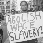"Abolish wage slavery!". Protesters marching to different targets in Manhattan and to Union Square Park. Photo taken by Javier Soriano/www.JavierSoriano.com on 5/1/2014.