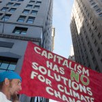 9/22/2014. NYC - "Capitalism has no solutions for climate change." A protester on Broadway and Wall St. in the lower Manhattan ("El capitalismo no tiene soluciones para el cambio climático." Un manifestante en Broadway y Wall St. en el bajo Manhattan).