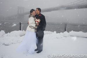 Brooklyn Bridge Park, NYC - It was Winter. It was snowing. We had so much fun creating this wedding photo. I am a wedding storyteller. I create photographs/videos that you, your children and grandchildren will love for many years. I love photography/videography. I love weddings. I love couples. I love people! It will be an honor to create your wedding pictures/videos. Photo by Javier Soriano/www.JavierSoriano.com