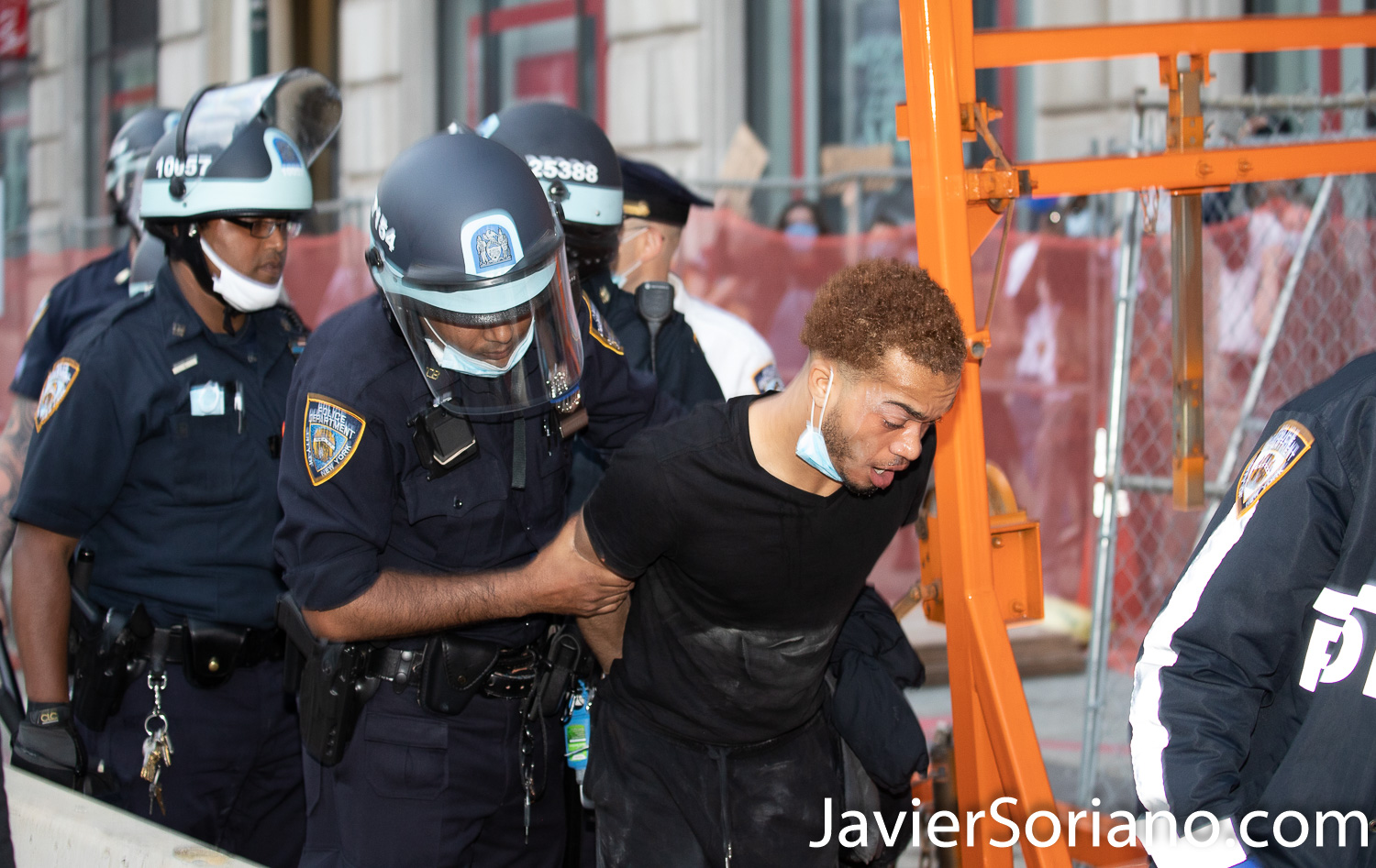 Tuesday, June 2, 2020. New York City - March from The Stonewall Inn to the Lower Manhattan to demand justice for George Floyd, Breonna Taylor, and too many others victims of police violence in the United States of America. NYPD officers arrested a young man. I don't know why officers arrested him. It looks like officers pepper sprayed him. I have seem other people when police officers pepper spray them. Photo by Javier Soriano/www.JavierSoriano.com