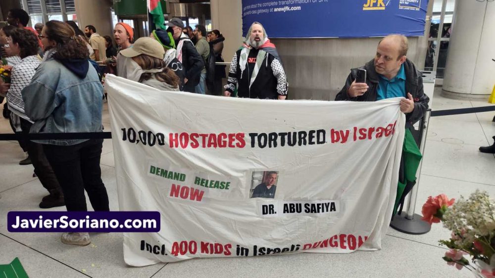 Sunday, May 24, 2026. Occupied Queens, Lenapehoking (New York City). - 15 U.S. humanitarians of the Global Sumud Flotilla arrived at the John F. Kennedy airport in New York City, on May 24, 2026. Pro-Palestine, anti-genocide New Yorkers went to the airport to welcome them. Protestors had different banners. This banner says, “10,000 hostages tortured by Israel. Incl. 400 kids in Israeli dungeons. Demand release now. Dr. Abu Safiya.” Photo by Javier Soriano/JavierSoriano.com.